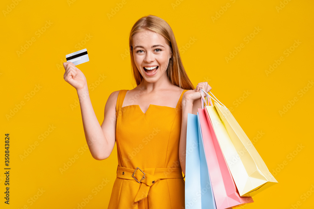 Sales And Discounts. Excited Girl Holding Shopping Bags And Credit Card Sales And Discounts. Excited Girl Holding Shopping Bags And Credit Card