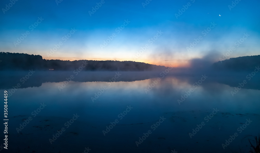 Mist over the lake dawn early morning in the summer