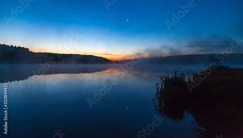 Fototapeta Naklejka Na Ścianę i Meble -  Mist over the lake dawn early morning in the summer