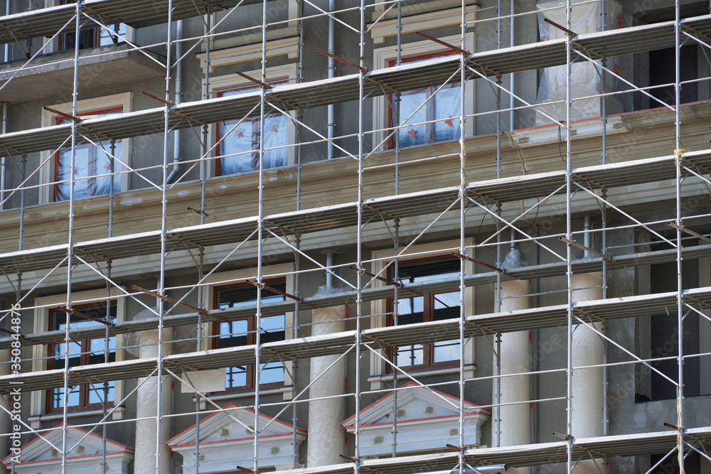 scaffolding at the facade of a building under construction, multi-storey building, without people scaffolding at the facade of a building under construction, multi-storey building, without people