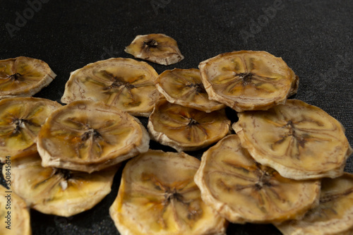 Dried bananas on a black background, banana chips