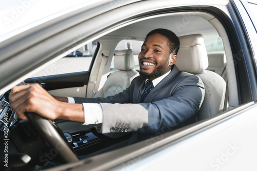 Joyful Man Driving Car Sitting Holding Steering Wheel © Prostock-studio