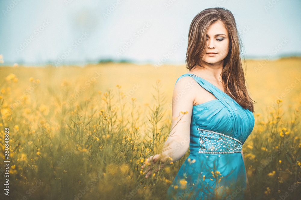 beautiful romantic girl on blooming rapeseed field enjoying nature, young elegant woman walks beautiful romantic girl on blooming rapeseed field enjoying nature, young elegant woman walks
