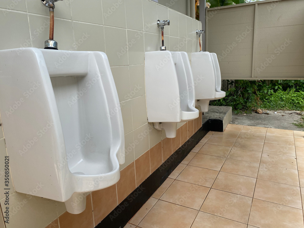 Men's white urinals design, Close up row of outdoor urinals men public