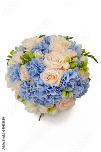 wedding bouquet of cream roses, freesia and blue hydrangeas on white background