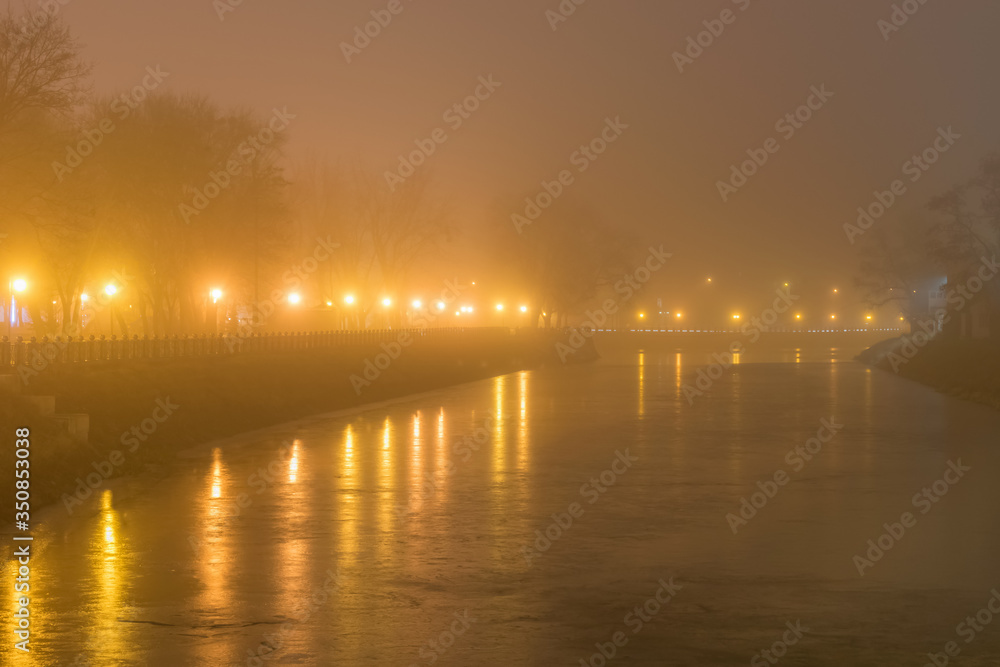 Night landscape with fog and lanterns on the banks of a frozen river in Strelka Kharkiv square Night landscape with fog and lanterns on the banks of a frozen river in Strelka Kharkiv square