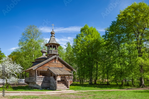 Wooden Church in the forest in summer against the sky