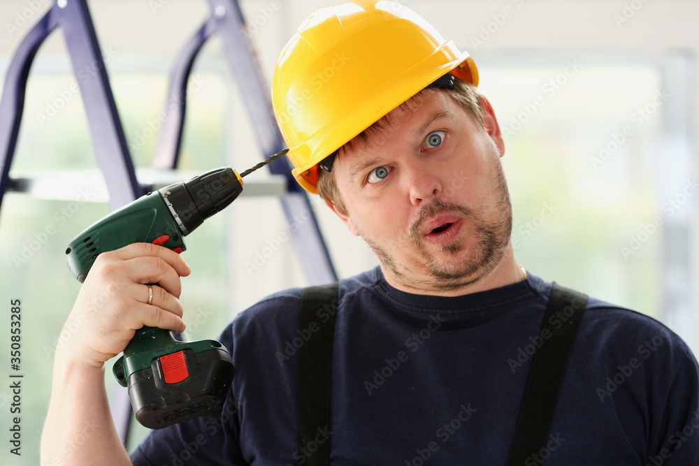 Idiot worker using electric drill portrait Idiot worker using electric drill portrait