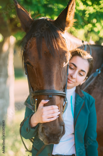 portrait of young georgian female horse rider with her horse