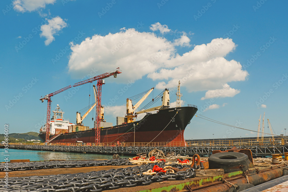 Big ship moored on huge floating dock with cranes for repair in shipyard. Big ship moored on huge floating dock with cranes for repair in shipyard.