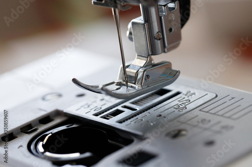 Sewing machine close-up. Sewing and manufacturing of clothes