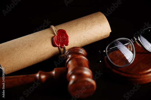 Wooden gavel and testament and last will. Notary public tools close-up.