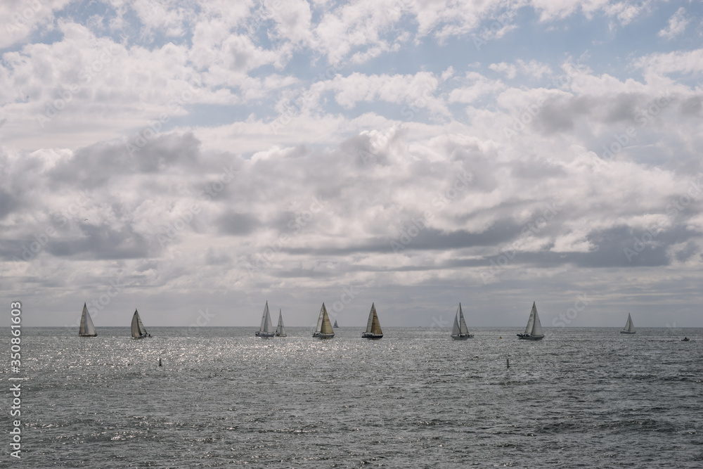 Sailboats Sailing On Sea Against Cloud Sky