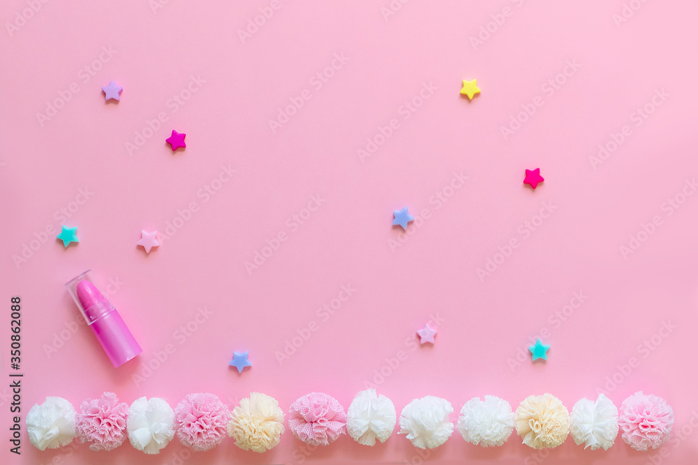Bright children's hair accessories on a pink background. Pink text background with children's hair ornaments