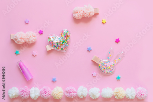 Bright children's hair accessories on a pink background. Pink text background with children's hair ornaments
