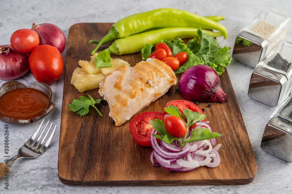 Chicken steak placed on a wooden tray. Chicken steak placed on a wooden tray.