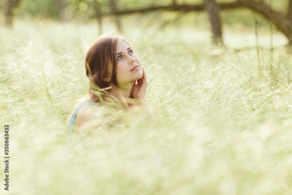 beautiful romantic girl sitting on field of spikelets and enjoying nature, young elegant woman walking beautiful romantic girl sitting on field of spikelets and enjoying nature, young elegant woman walking