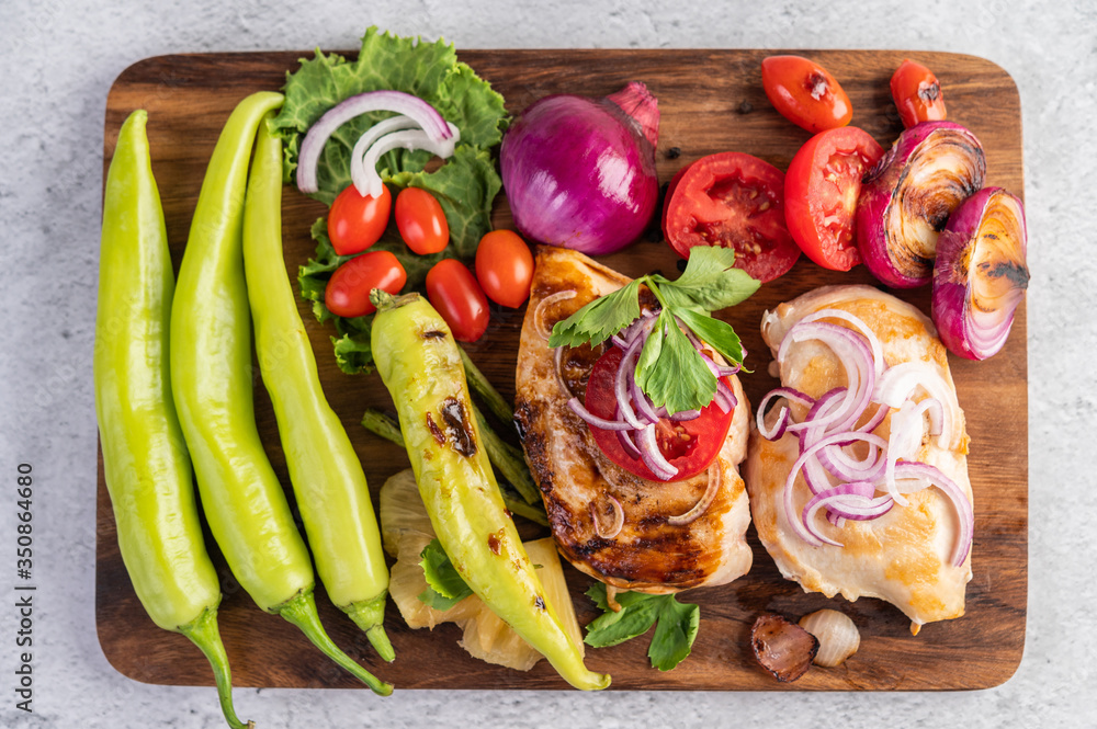 Chicken steak placed on a wooden tray. Chicken steak placed on a wooden tray.