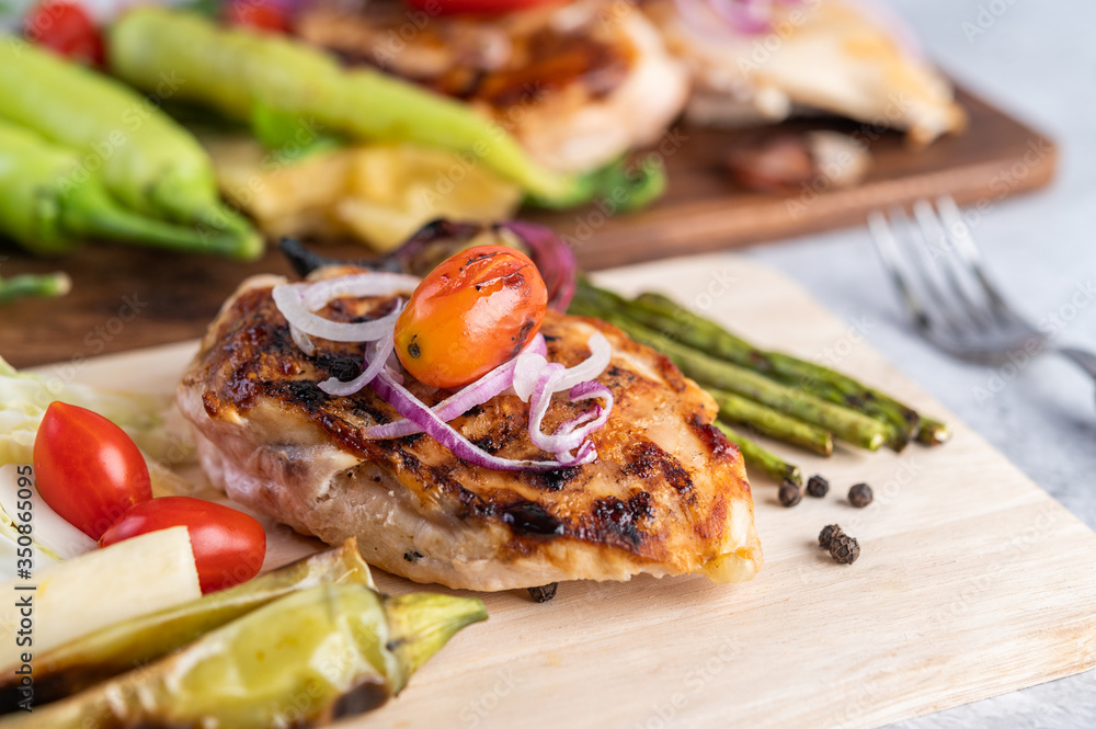 Chicken steak placed on a wooden tray. Chicken steak placed on a wooden tray.