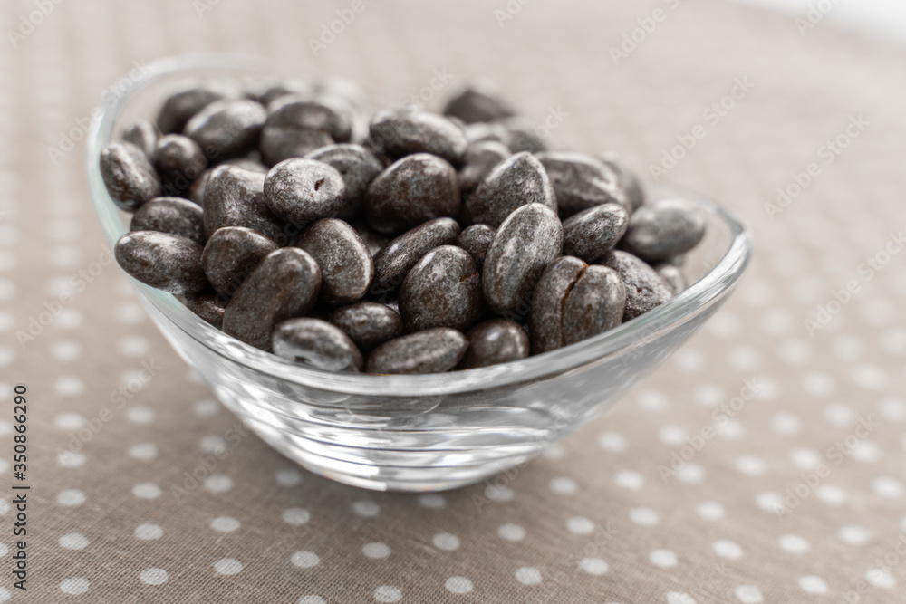 raisins in chocolate in a marble shiny glaze in a glass bowl raisins in chocolate in a marble shiny glaze in a glass bowl