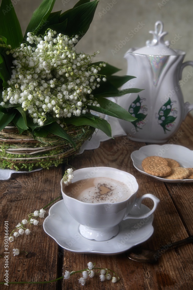 Cup of coffee and cookies with bouquet of spring flowers Cup of coffee and cookies with bouquet of spring flowers