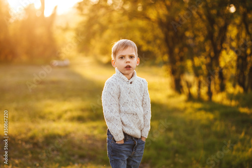 Boy in the forest.  Sunset sun. 
Surprised face