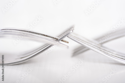 Close up detail of fork on white background, abstract art background design concept, connection and touching