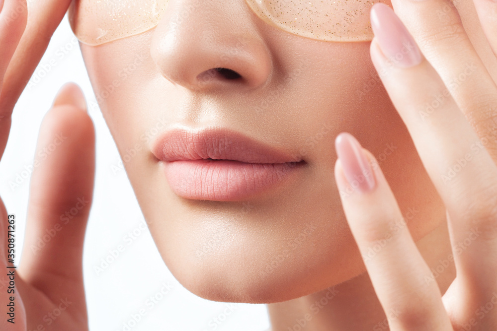 Young beautiful woman with clean perfect skin with cosmetic patches on face close-up Young beautiful woman with clean perfect skin with cosmetic patches on face close-up