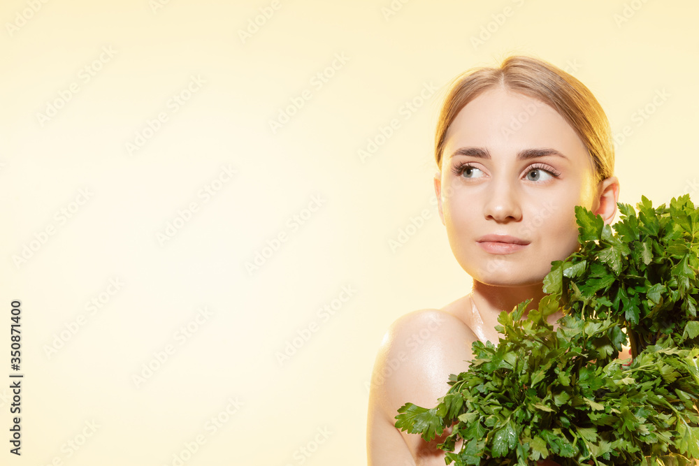 Close up of beautiful young woman with green leaves on white background. Concept of cosmetics, makeup, natural and eco treatment, skin care. Shiny and healthy skin, fashion, healthcare. Close up of beautiful young woman with green leaves on white background. Concept of cosmetics, makeup, natural and eco treatment, skin care. Shiny and healthy skin, fashion, healthcare.