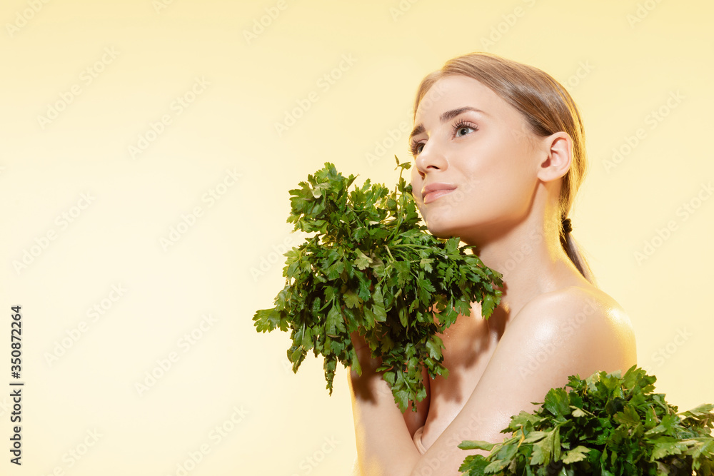 Close up of beautiful young woman with green leaves on white background. Concept of cosmetics, makeup, natural and eco treatment, skin care. Shiny and healthy skin, fashion, healthcare. Close up of beautiful young woman with green leaves on white background. Concept of cosmetics, makeup, natural and eco treatment, skin care. Shiny and healthy skin, fashion, healthcare.