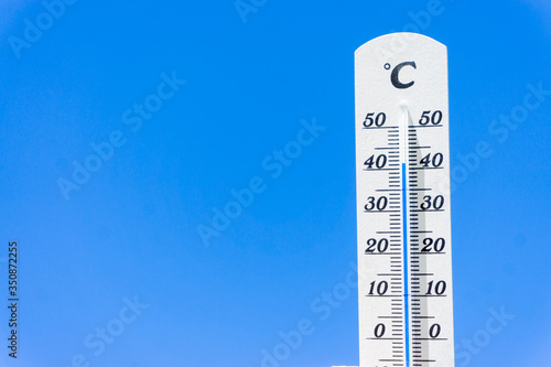 thermometer and sky, heatwave in summer