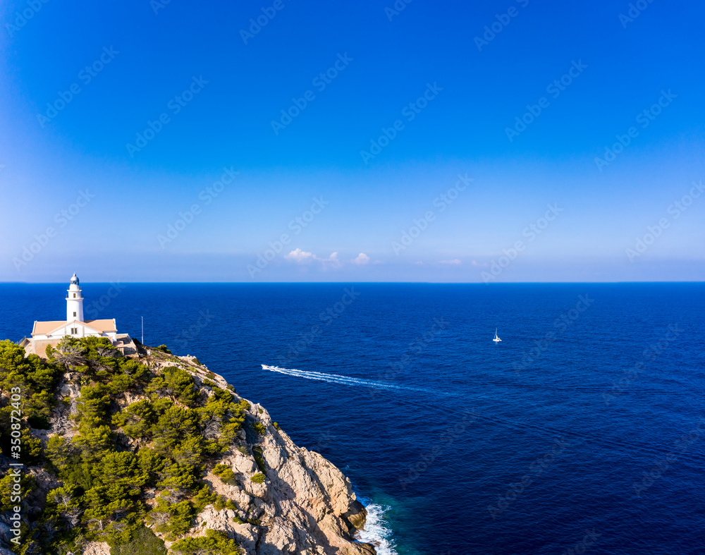 Aerial view lighthouse Far de Capdepera with cliffs, Cala Ratjada, Mallorca, Balearic Islands, Spain