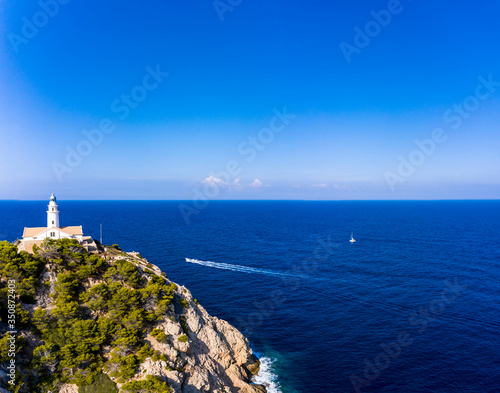 Aerial view lighthouse Far de Capdepera with cliffs, Cala Ratjada, Mallorca, Balearic Islands, Spain