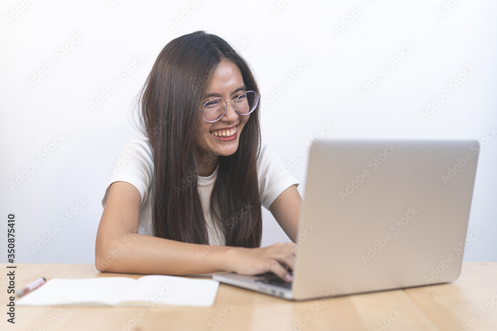 Asian girl uses a laptop computer and video call with a friend in the home. Asian girl uses a laptop computer and video call with a friend in the home.
