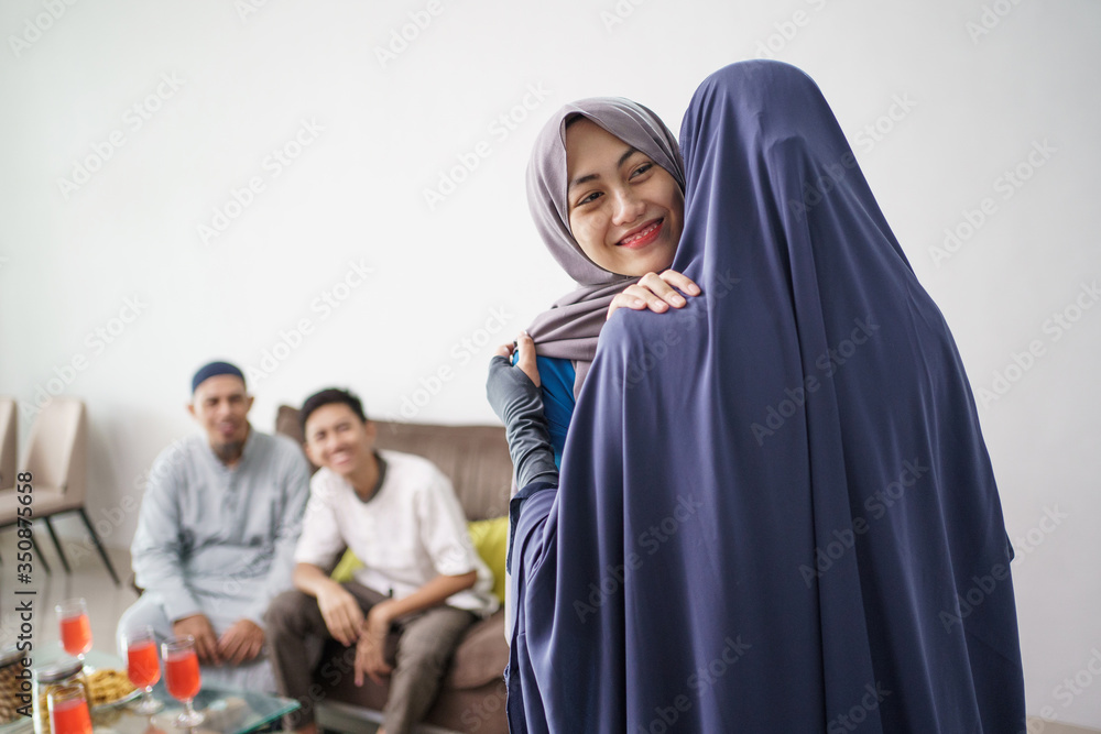 portrait of happy mother hug her daughter during ramadan visit