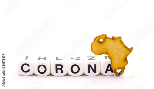 The shape of the African continent and the text word corona isolated on a clear background image with copy space in horizontal format