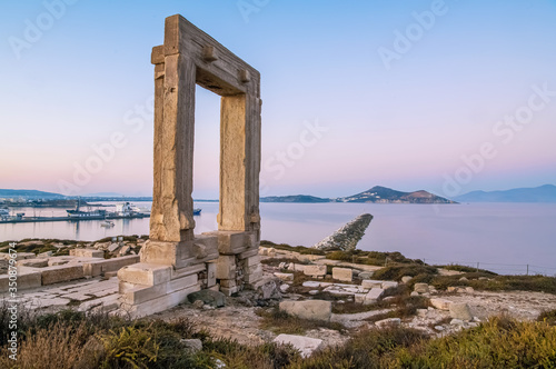 Breathtaking scenery on ancient portal of Apollo Temple at dawn in Greek Naxos island. Beautiful landscape and light backgound. Romantic and tranquill place.