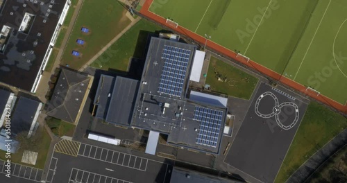 School with solar panels and playground area in sunshine, England, UK