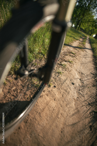 Bicycle front wheel closeup in motion during summer evening