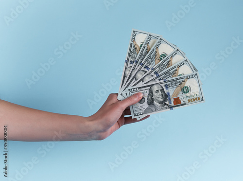 Hand holding hundred dollars. Giving money. 500 american USD isolated in hand