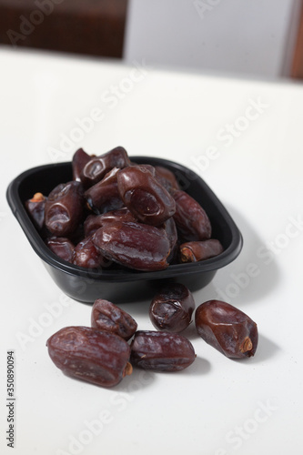 Dried dates fruits on white background, tasted sweet and chewy photo