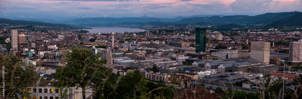 Zurich city Switzerland panorama from famous vista point in the evening after sunset cloudy sky