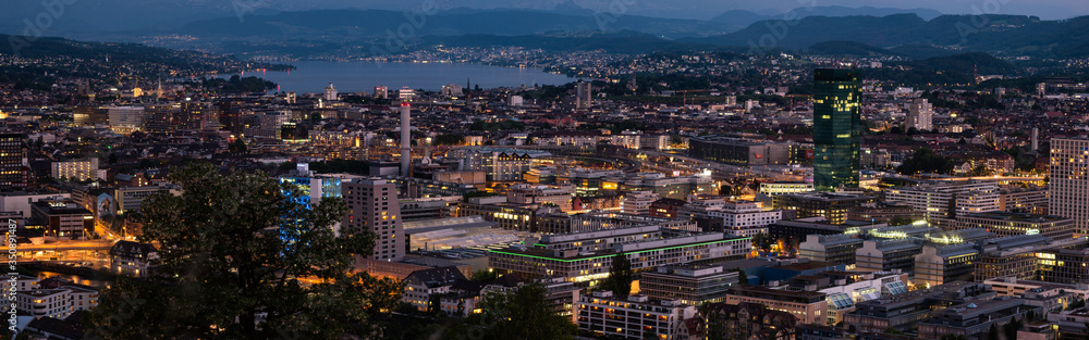 Zurich city Switzerland panorama from famous vista point late evening blue hour evening after sunset cloudy sky