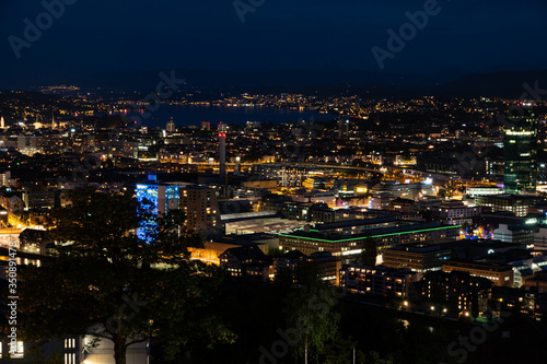 Zurich city Switzerland view from famous vista point late evening blue hour evening after sunset cloudy sky