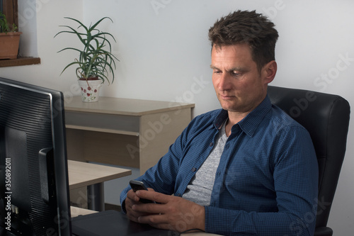 Caucasian adult male working at home office during coronavirus pandemic photo