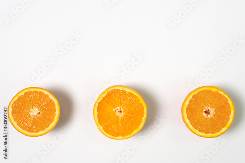 Three half sliced fresh orange with white background