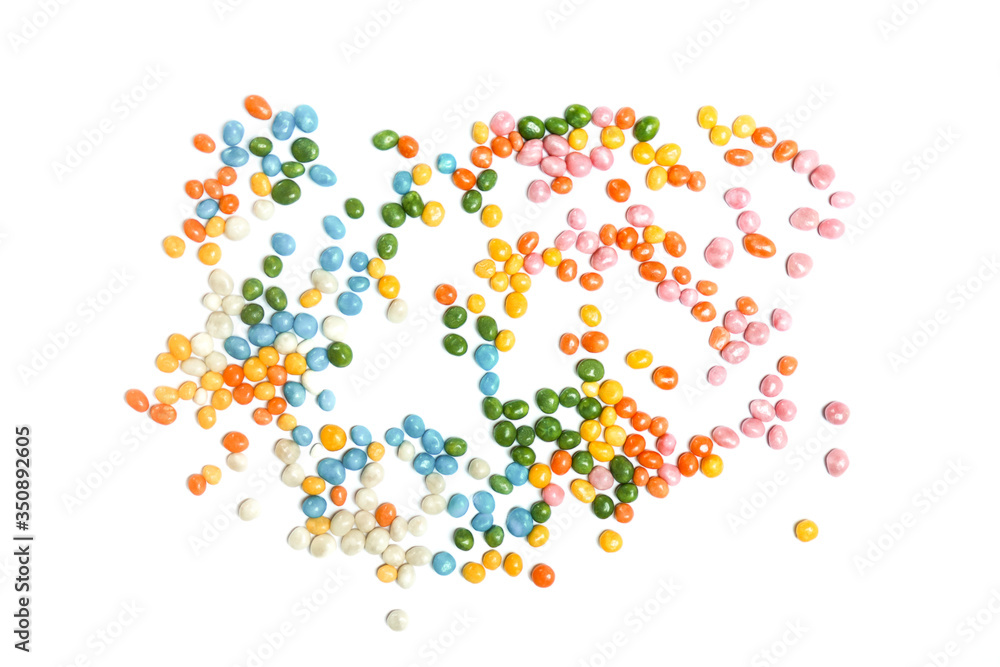 Assorted bean candies on white background, unorganised, chaos.