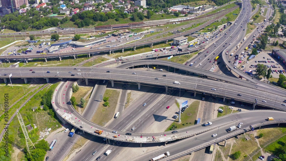 top shot of a modern industrial motor vehicle interchange with overpasses and bridges. part on reconstruction with speed limits to a minimum. aerial view 