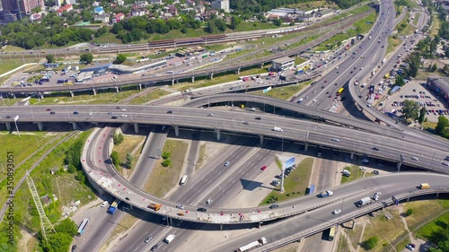 top shot of a modern industrial motor vehicle interchange with overpasses and bridges. part on reconstruction with speed limits to a minimum. aerial view 