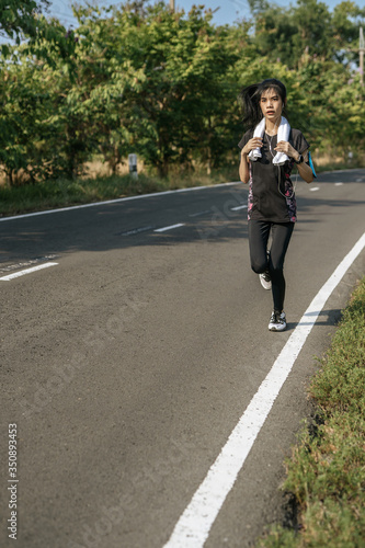 women exercise by running on the road. © Johnstocker